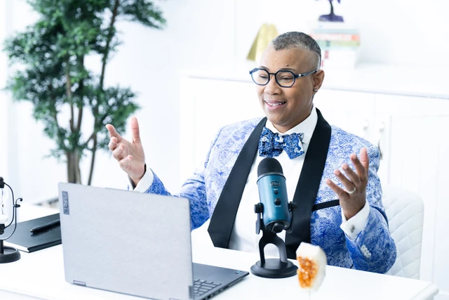 Karen Anastasia Prescod speaking at her computer with a microphone